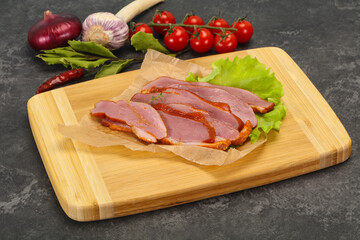 Sliced smoked duck breast served salad