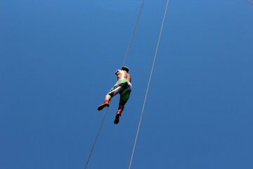 man climbing on a rope
