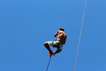 man climbing the rope