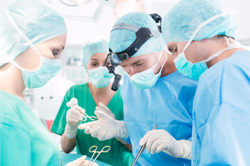 Surgeons operating patient in operation theater