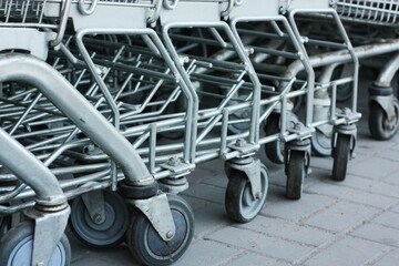 Fototapeta na wymiar Iron carts for products near the store 