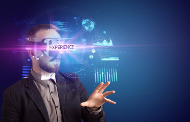 Businessman looking through Virtual Reality glasses with EXPERIENCE inscription, new business concept