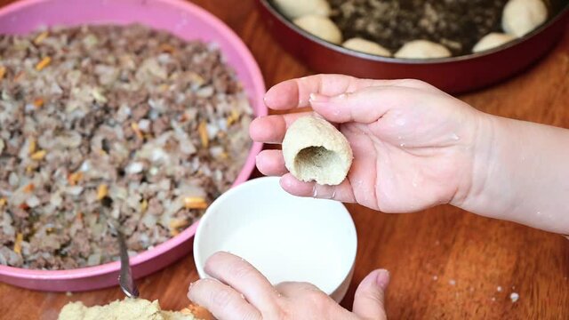 Woman hands making and preparing middle eastern traditional food. Delicious Kibbeh, famous in Arabic country especially in  Lebanon, Syria.