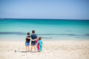 Children On a Beach Looking Out at the Horizon 