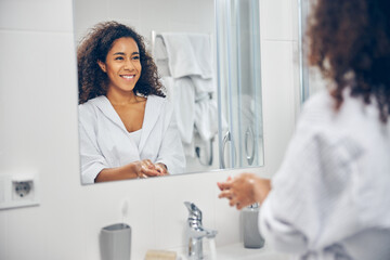 Woman with a happy smile standing in the bathroom