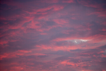 crimson clouds in the sky in the evening at sunset