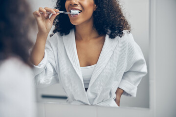 Female cleaning her teeth with a toothbrush