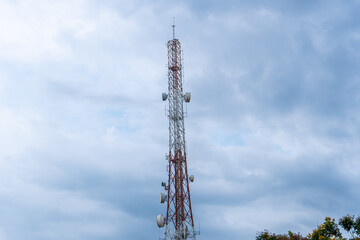 Telecommunication tower Antenna and satellite dish with sky background.