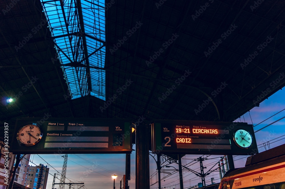 Poster low angle shot of electric signboards in the train station in spain