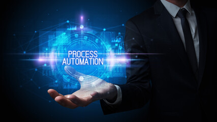 Man hand holding PROCESS AUTOMATION inscription, technology concept