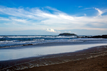 Wild coast of the South China Sea with waves and small volcanic islands in Mui Ne, Vietnam