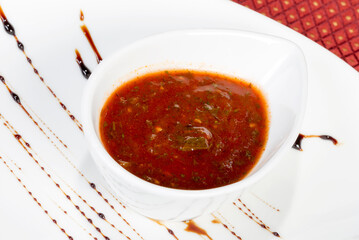 spicy tomato sauce in a gravy boat white. As backdrop for menus, cookbooks, advertisements and other culinary projects