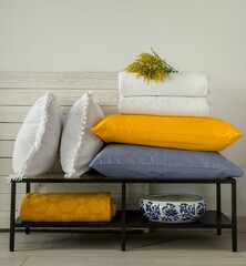 Yellow and white decorative pillows and blankets in the bedroom