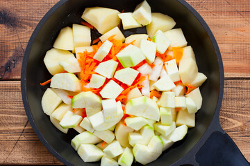 Step by step preparation of vegetable stew with turkey, step 4 - adding raw chopped zucchini, top view, selective focus