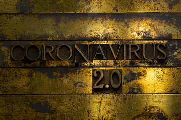 Coronavirus 2.0 text formed with real authentic typeset letters on vintage textured silver grunge copper and gold background