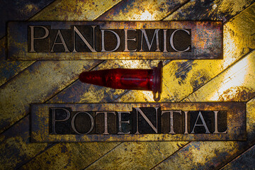 Pandemic Potential text formed with real authentic typeset letters on vintage textured silver grunge copper and gold background