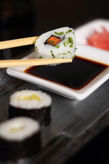 Chopsticks holding sushi