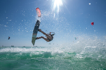 Kite girl rides in the ocean clear water