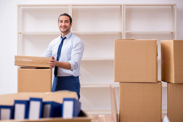 Young male employee in relocation concept