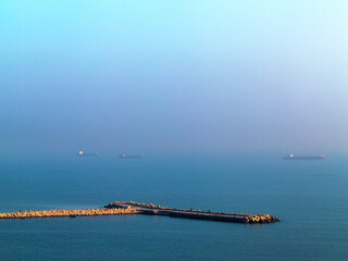 Beautiful seascape sunset with the horizon line disappears in the fog.