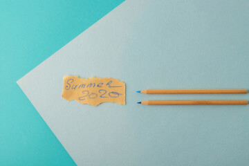 summer 2020 concept on blue background with wooden pencils