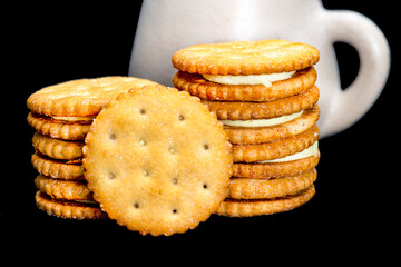 lemon-filled biscuits with a rustic ceramic cup behind