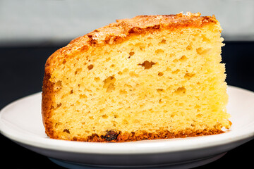 portion of homemade sponge cake on white plate