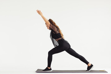 Slim girl practicing yoga isolated on white background. , Warrior 1 posture, Virabhadrasana....