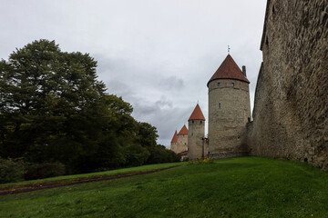 Fototapeta premium Walls of an old castle with towers in the center of Tallinn's old town