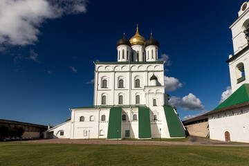 Fototapeta na wymiar View of the Pskov Kremlin near the city river on a summer clear day. Trails for walking tourists.