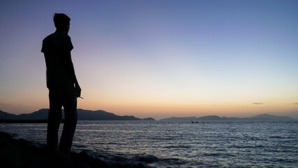 Fototapeta premium silhouette of a man on the beach at sunset