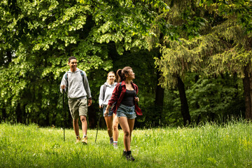 Obraz premium Group of young people hiking trough forest.Outdoors nature concept. 