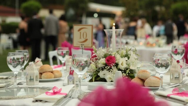 dinner wedding decoration white table 
preparation hotel garden flowers close up. Cinematic save the date wedding clip