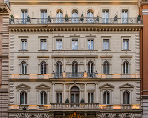 Fototapeta na wymiar illuminated vintage building facade windows pattern, Rome Italy
