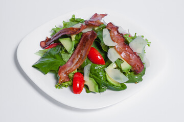 tasty green fresh salad with bacon isolated