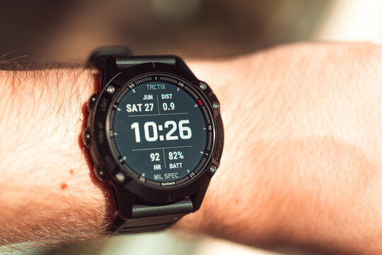 Garmin Fenix 6 smart watch on man's hand. Using smart watch or fitness tracker.