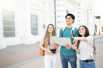 Young Friends With Map In City
