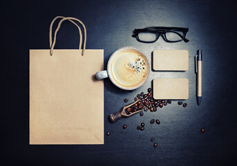 Blank kraft corporate stationery set on black wooden background. Template for branding design. Top view. Flat lay.