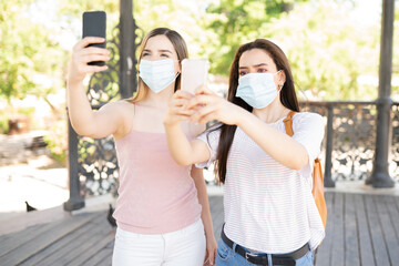 Women Taking Selfies While Wearing Face Masks