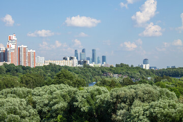 Naklejka premium Panoramic view of modern residential buildings in Moscow Russia on a clear Sunny summer day with green trees a copy space