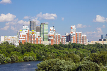 Fototapeta premium Panoramic view of modern residential buildings in Moscow Russia on a clear Sunny summer day with green trees a copy space