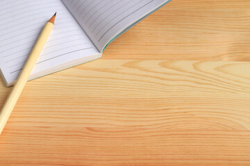 Blank Lined Notebook and Pencil Isolated on Wooden Table with Copy Space