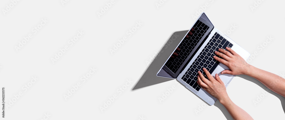 Poster person using a laptop computer from above