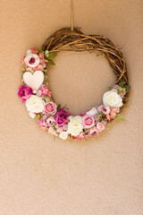 Beautiful floral wreath, home ornament hangs on wall.