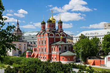 Fototapeta na wymiar Patriarchal courtyard of churches in Zaryadye Park on a clear summer day against the background of green trees and blue sky in Moscow Russia