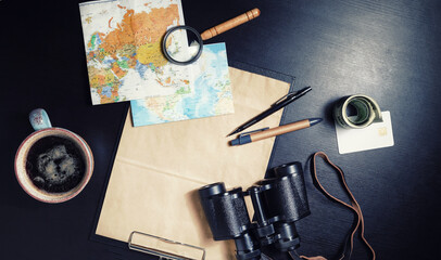 Preparation for travel. Tourist devices on black table background. Flat lay.