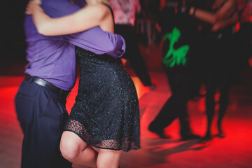 Couples dancing argentinian dance milonga in the ballroom, tango lesson in the red lights, dance festival - obrazy, fototapety, plakaty
