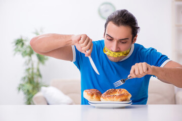 Young hungry man in dieting concept