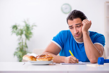Young hungry man in dieting concept