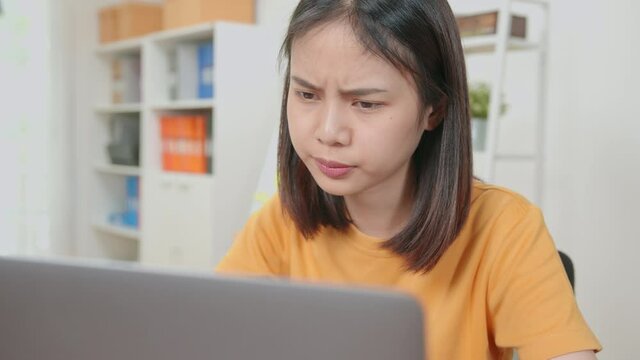 Asian business women feeling headache from hard work and from using the computer for a long time in the desk office room.